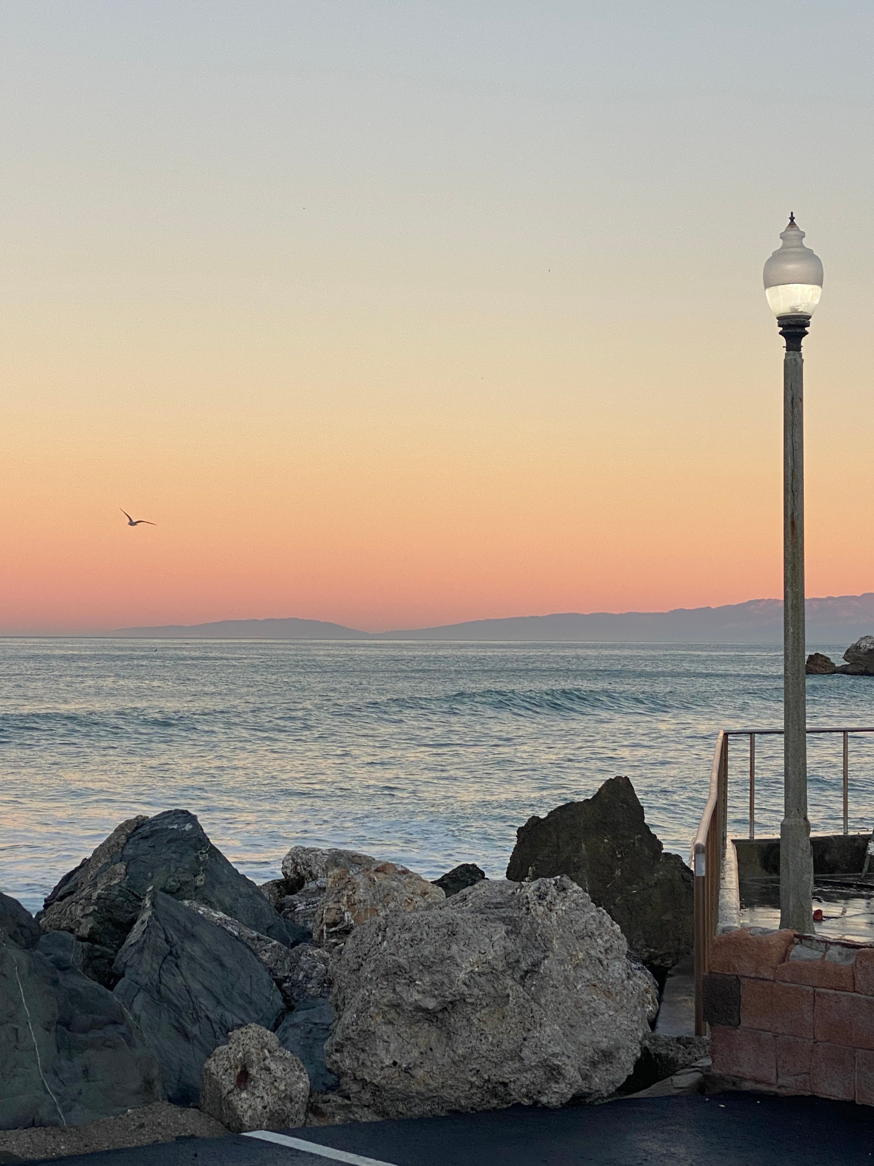Pacifica coast at sunset with a waterfront lamp