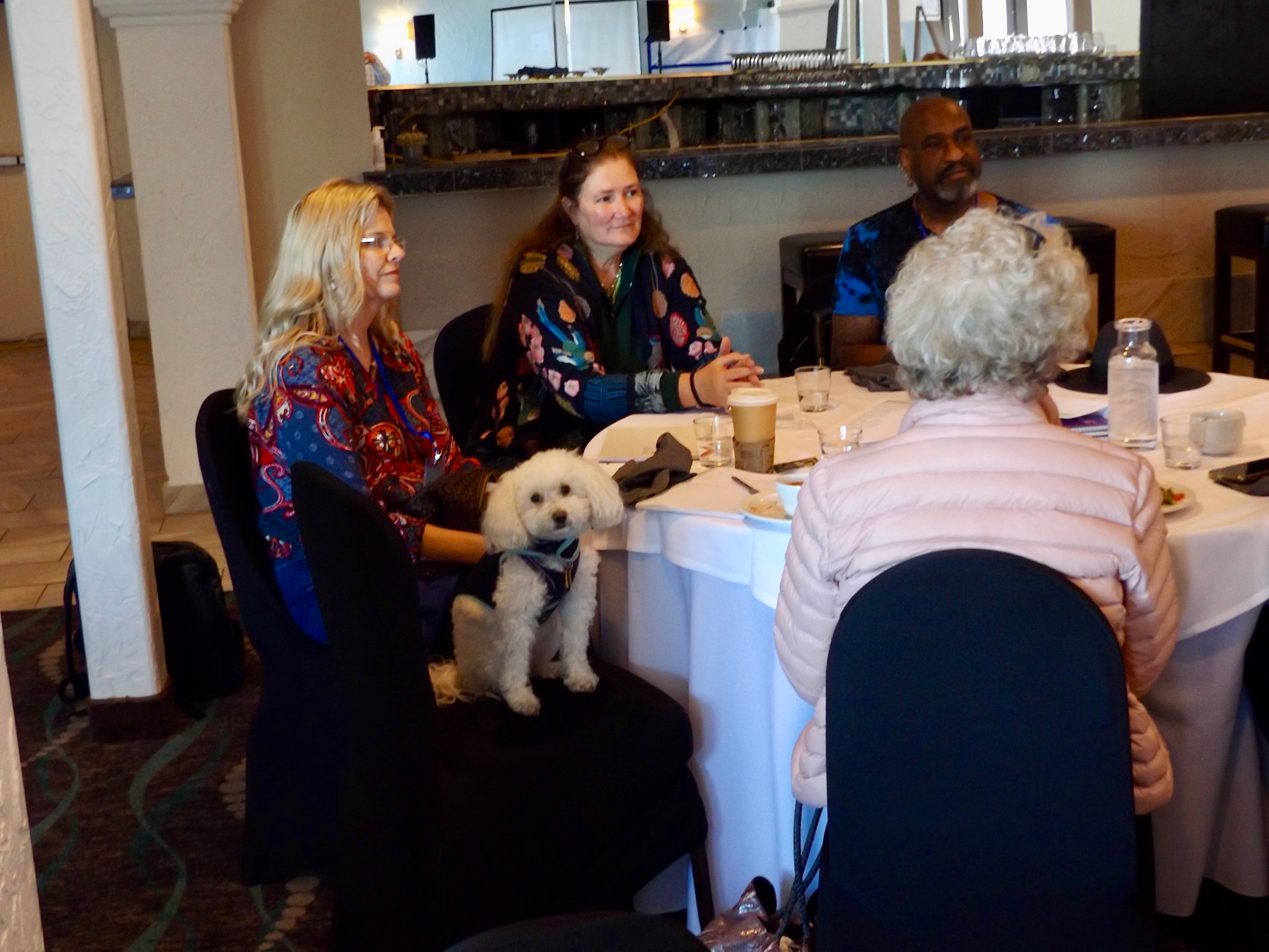 Gathering participant with a dog indoors