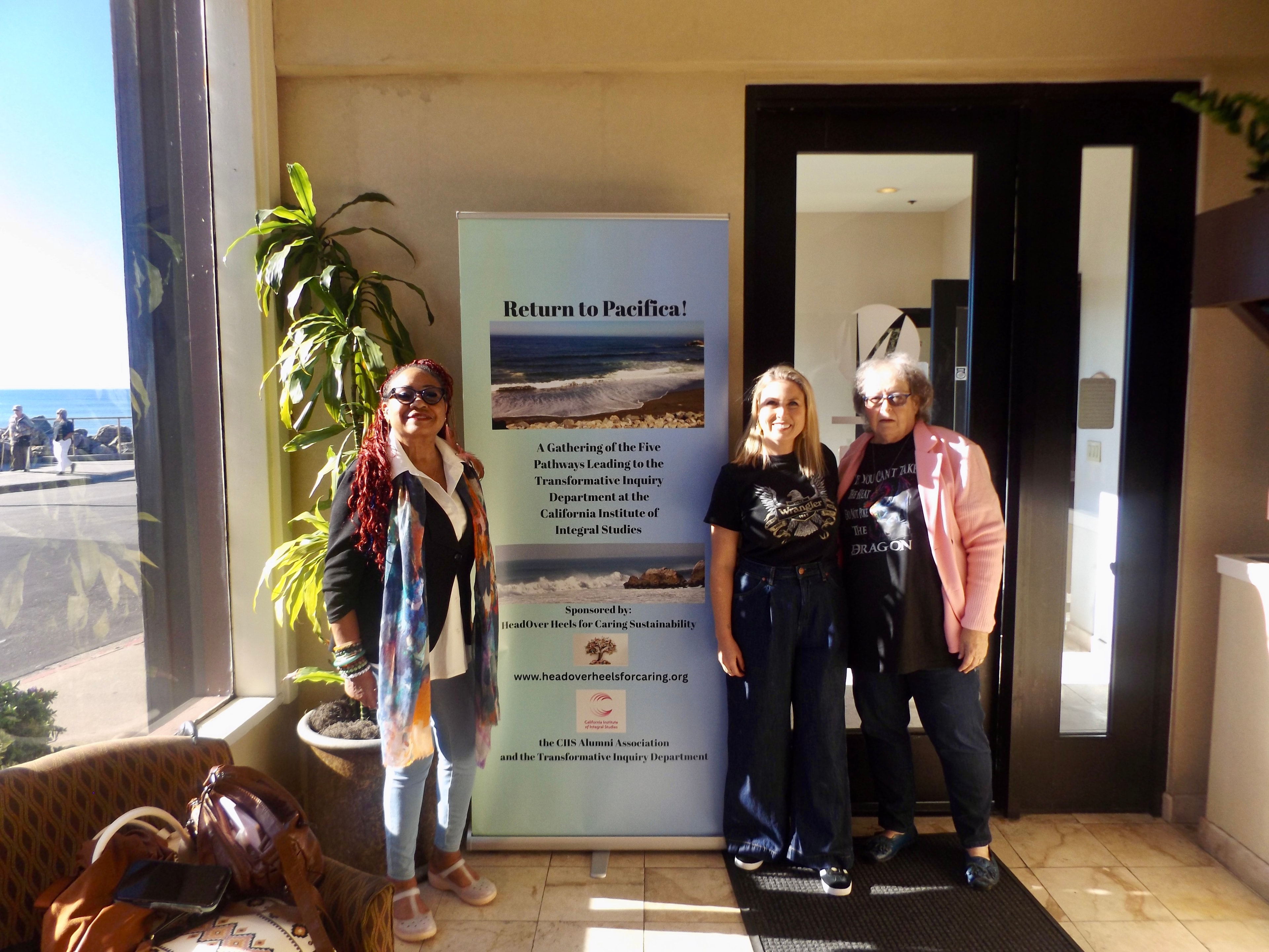 Gathering participants beside event signage