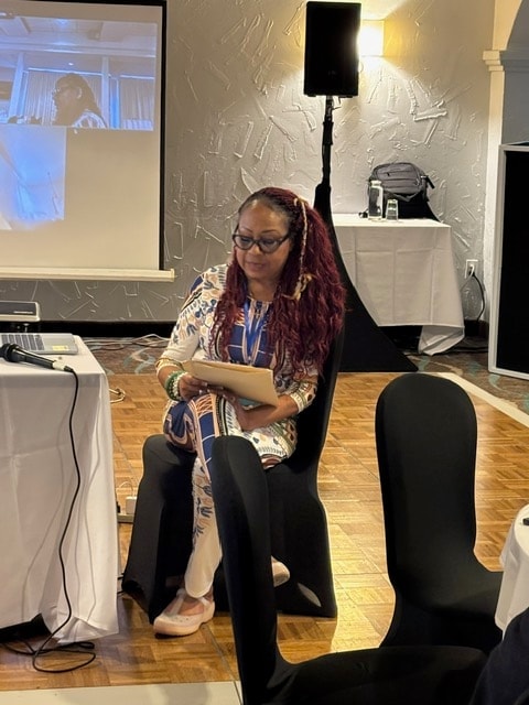 Gathering attendee seated with a tablet in the event space