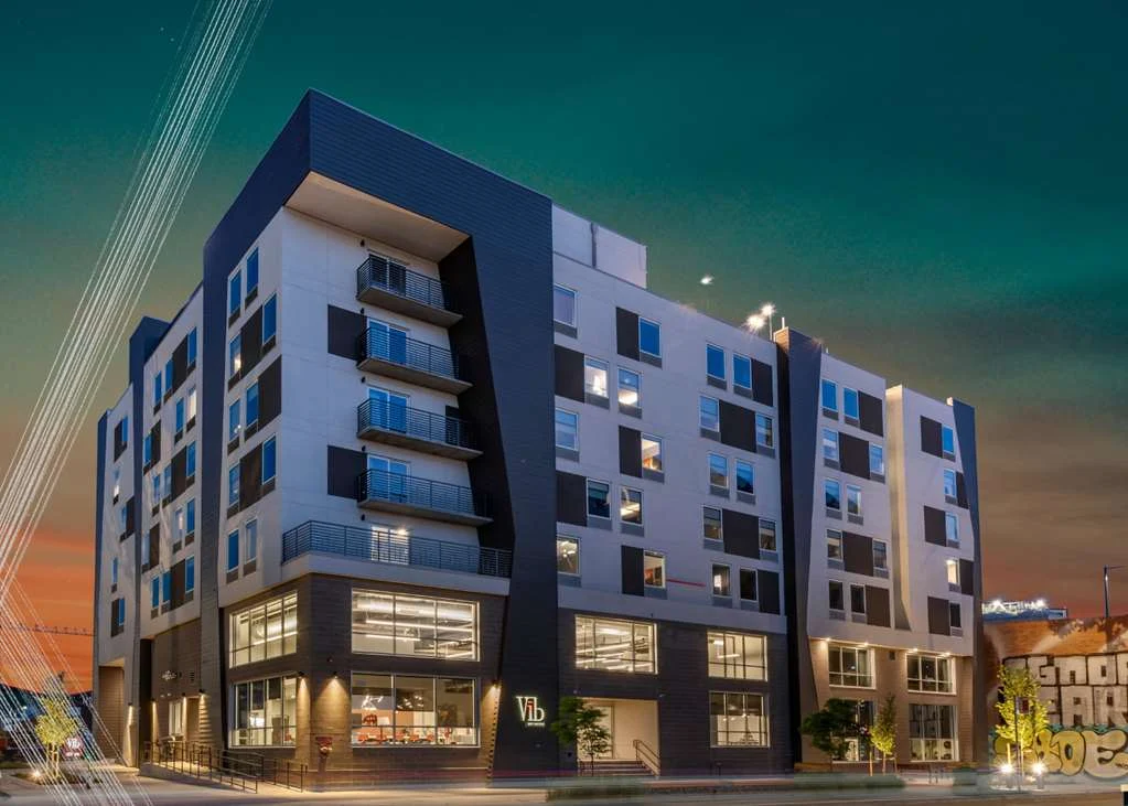 Modern apartment building at dusk.